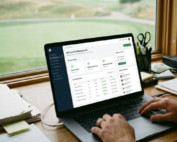 A person using a laptop with a Membership Management dashboard in a sunlit office overlooking a golf course green.